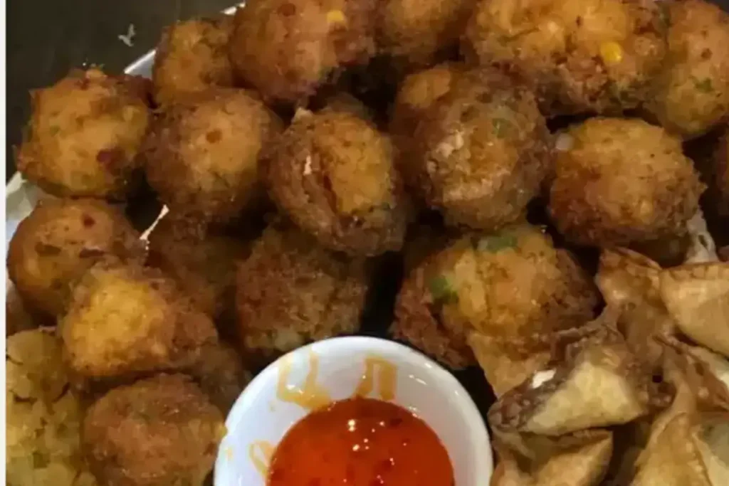 Delicious hush puppies with hot sauce, perfect sides for fried fish.