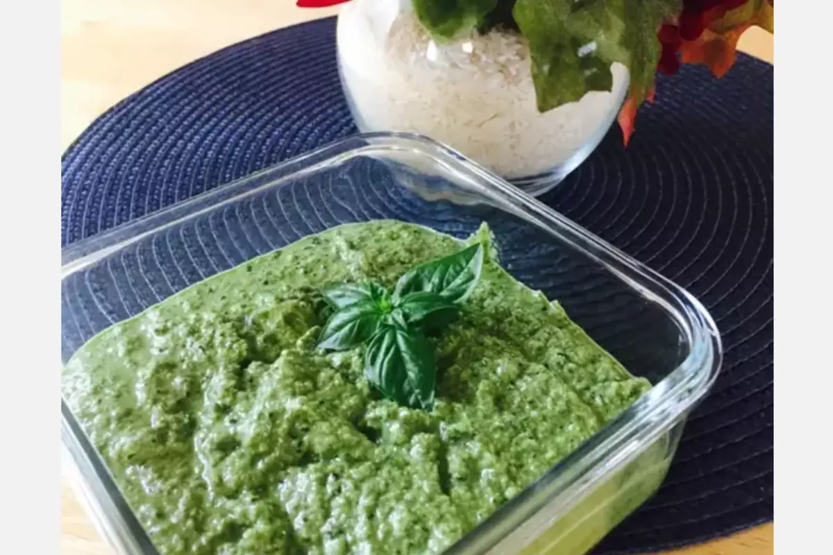 Glass bowl filled with fresh pesto sauce